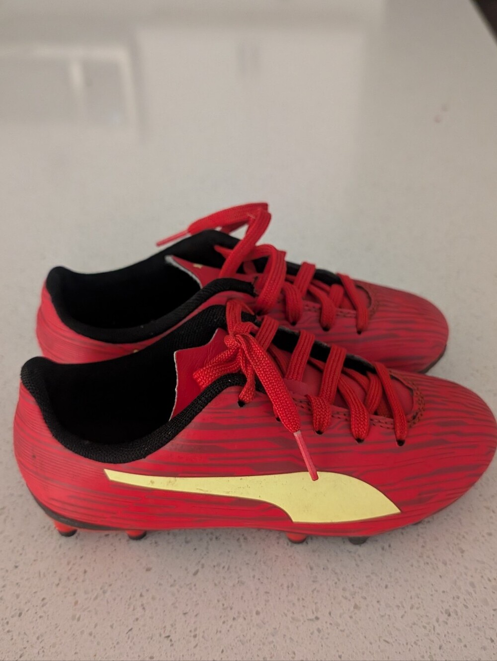 Puma | Kids Red Soccer Cleats with Yellow Accent